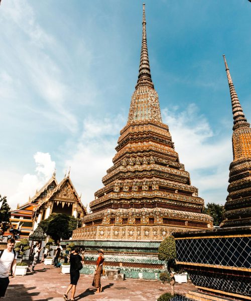pexels-photo-2797526-2797526 Stunning view of traditional pagodas at Wat Pho under a vibrant blue sky in Bangkok, Thailand.