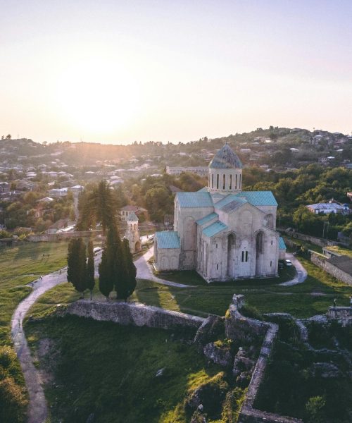 pexels-photo-2990775-2990775 Aerial view of Bagrati Cathedral in Kutaisi, Georgia, showcasing stunning landscape at sunrise.