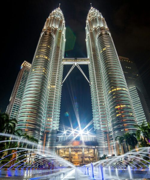 pexels-photo-462671-462671 Stunning night view of the illuminated Petronas Twin Towers in Kuala Lumpur with fountains in the foreground.