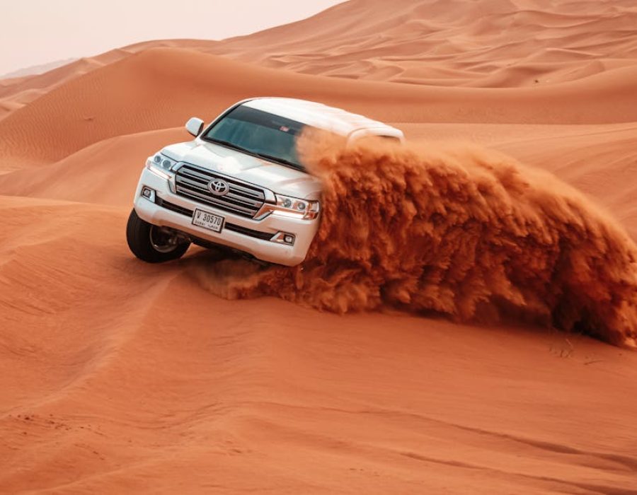 pexels-photo-4781951-4781951 A Toyota Land Cruiser drives through the vast sandy dunes on an exciting off-road adventure.